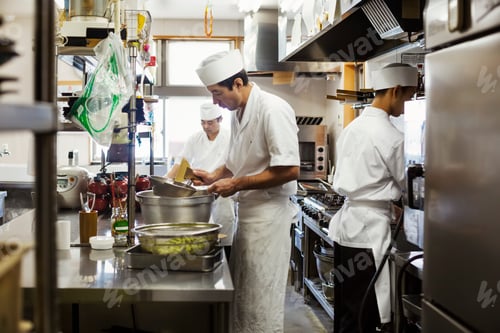 Preview: Two chefs working in the kitchen of a Japanese sushi restaurant.