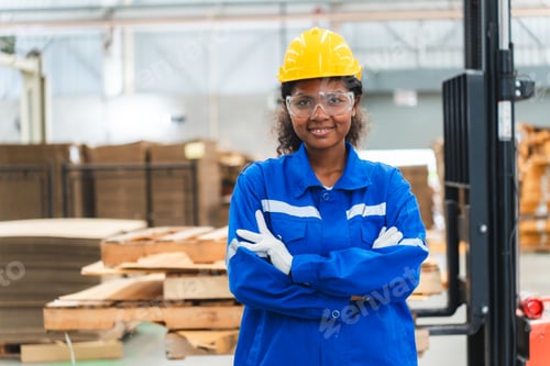 Preview: Portrait female professional engineer factory in protective uniform operating machine
