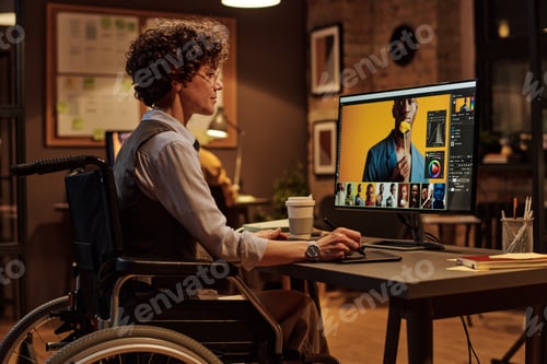 Preview: Woman with disability working as a designer at office