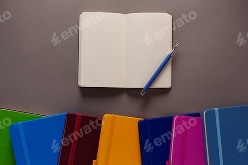 Preview: Open notepad and notebook heap on paper table background. Back to school concept idea