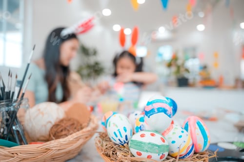 Preview: mother and child family making waster egg at home happy and fun together in holiday