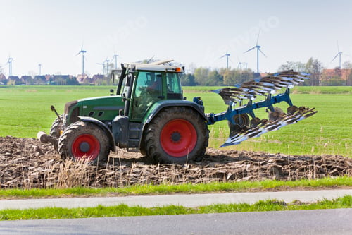 Preview: Tractor with plowes on the spring field.