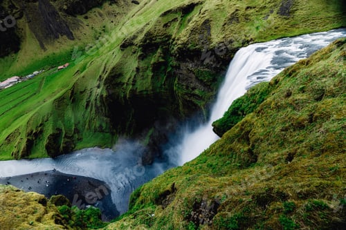 Preview: Scenic waterfall on a green mountainside