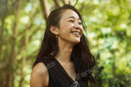 Preview: A young woman in woodland, outdoors.