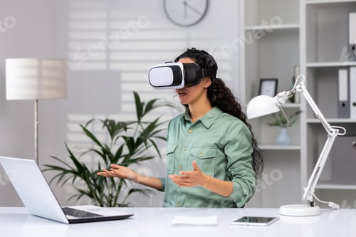 Preview: Successful latin american woman in office using vr glasses for video call and chatting online in
