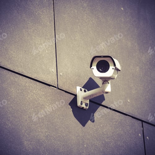 Preview: Security camera on gray office building wall