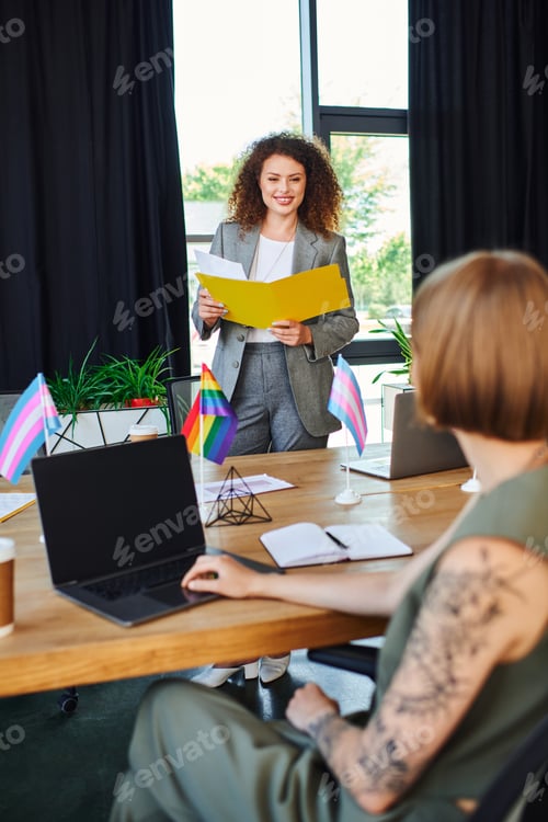 Preview: Engaged coworkers celebrate diversity during a meeting in a bright office space