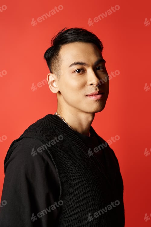 Preview: The stylish elegance: asian man in black t-shirt against vibrant red