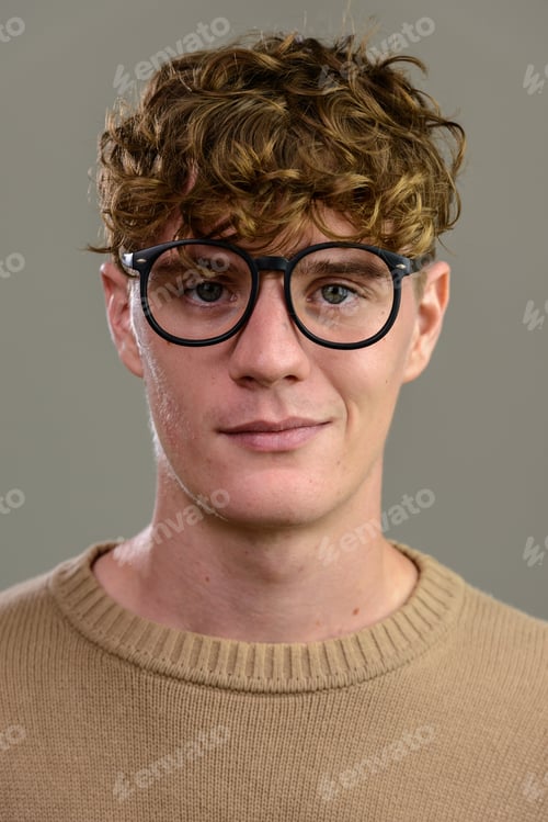 Preview: Face of young handsome man with eyeglasses looking at camera