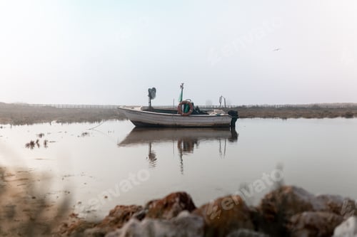 Preview: A small boat is floating alone surrounded by fog