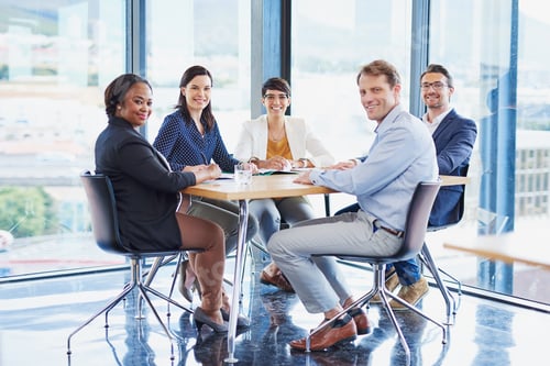 Preview: Portrait of a team of colleagues having a meeting in an office