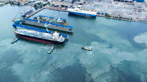 Preview: Tug boat pull cargo container ship from dry dock concept maintenance service working in the sea.