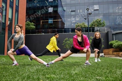 Preview: Young athletes engage in dynamic stretching in a modern urban park during a sunny afternoon