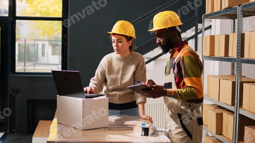 Preview: Two workers examining products stock