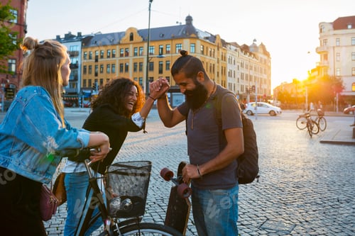 Preview: Friends doing high-five in town square