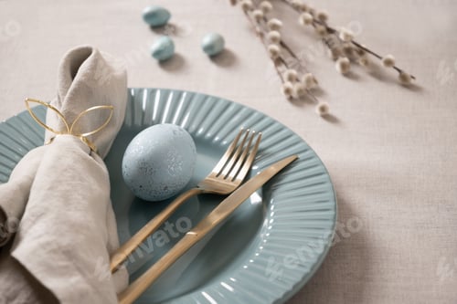 Preview: Easter table setting with blue egg and gold cutlery