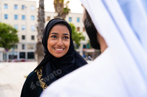 Preview: Traditional arab couple wearing emirati clothing dating outdoors