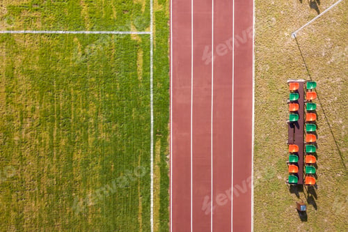 Preview: Top view of red running tracks and green grass lawn. Infrastructure for sports activities.