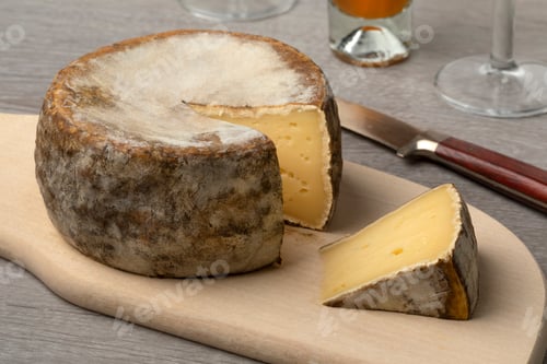 Preview: French Tommette de Montagne and a piece on a cutting board close up