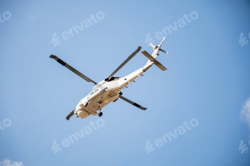 Preview: Modern helicopter in flight against blue sky displaying new rescue and transportation technology.