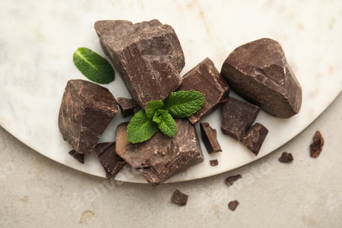 Preview: Tasty dark chocolate pieces with mint on white table, flat lay