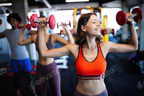 Preview: Healthy young athletes friends doing exercises at gym