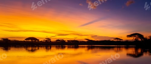 Preview: African sunset with a lake trees and mountains, sunset by a water lake in the Savannah South Africa