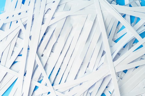 Preview: Shredded paper pieces on a blue background