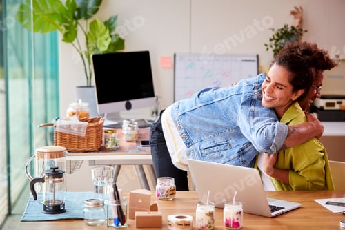 Preview: Couple Running Online Business Making Boutique Candles At Home Celebrating With Hug