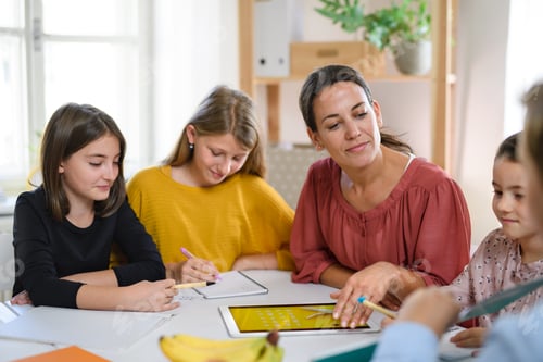 Preview: Group of homeschooling children with teacher studying indoors, coronavirus concept.