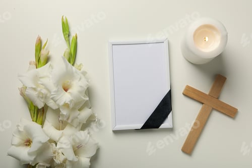 Preview: Candle, photo frame, flowers and cross on white background, top view