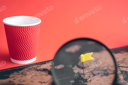 Preview: A flag stuck in a world map, close-up.