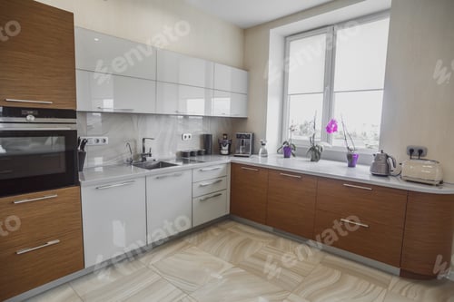 Preview: View of luxury modern fitted kitchen with stainless steel appliances
