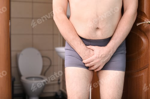 Preview: Mature man with urological problems suffering from pain near toilet
