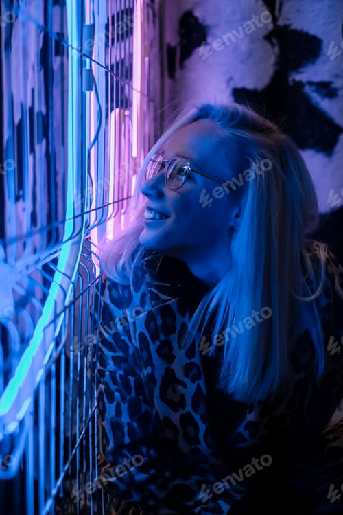 Preview: Woman face with glasses in metal frame reflect neon light