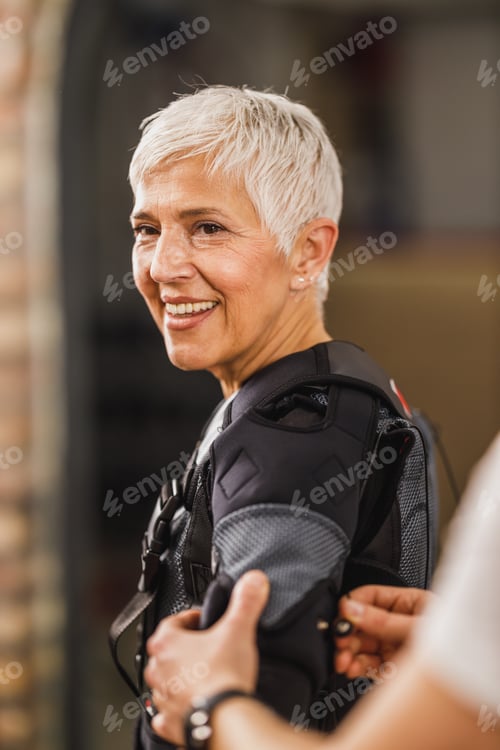 Preview: Fitness Instructor Putting An Ems Suit To A Woman