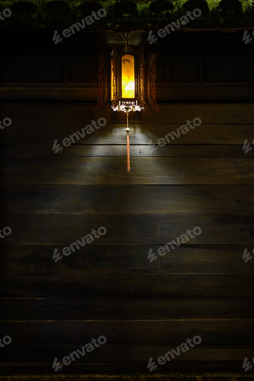 Preview: Dark wooden wall with glowing Chinese lantern in Hoi An in night time