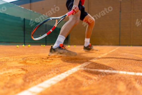 Preview: close-up of a tennis player's or instructor's foot on an outdoor court ground dust rising