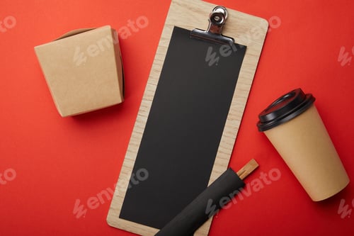 Preview: flat lay with arranged disposable coffee cup, chopsticks, wok box and blank menu on red surface