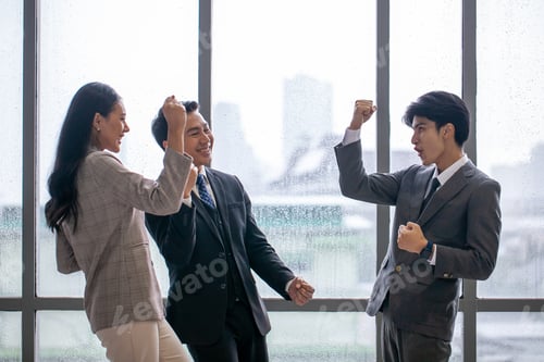 Preview: Asian business team celebrate corporate victory together in office.