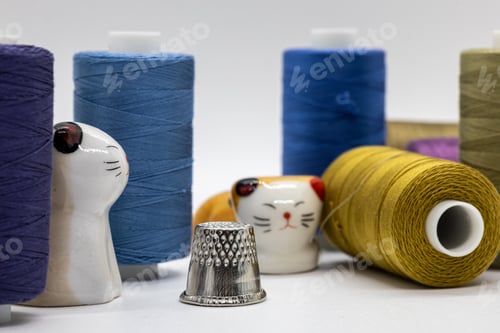 Preview: several different spools of thread sit in a pile on top of each other