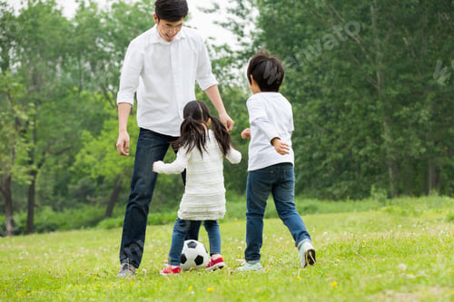 Preview: Happy father and children playing football together