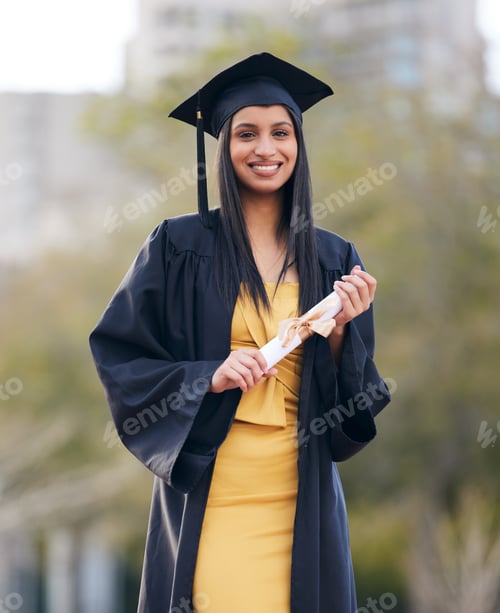 Preview: Portrait of a young woman holding her diploma on graduation day