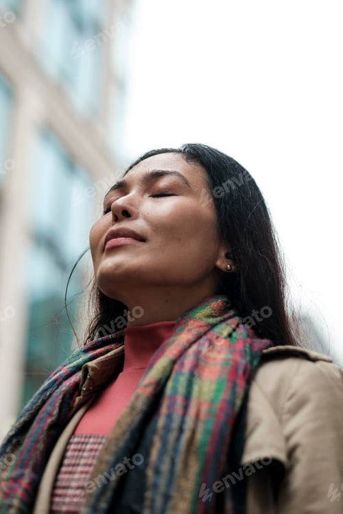Preview: Woman relaxing and breathing in fresh city air