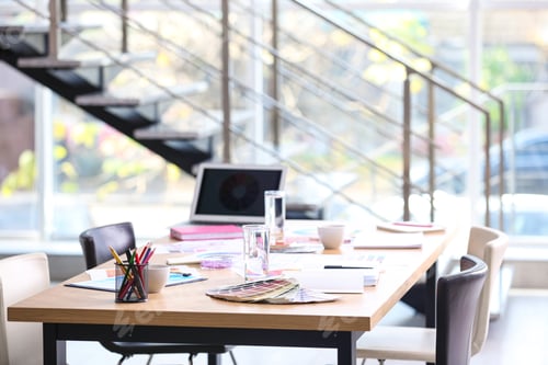 Preview: Meeting table with laptop and color palettes in interior designer's office