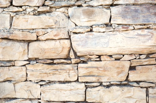 Preview: Masonry walls of natural sand color. Stone texture close-up, construction and mining background.