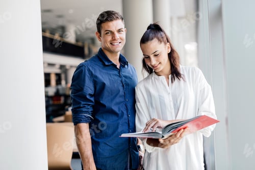 Preview: Two students reading and studying in library
