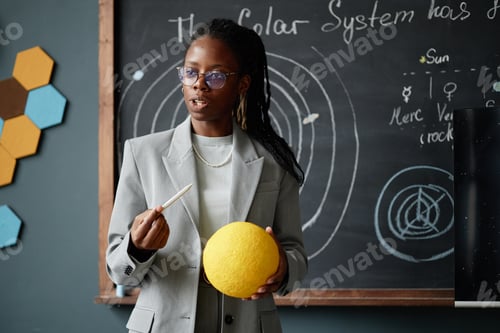 Preview: Young Adult Black Woman Explaining Solar System Model in Classroom Setting