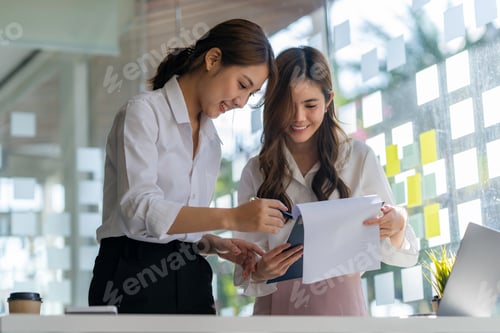 Preview: Two Young Asian businesswoman discuss with new startup project Idea presentation, analyze planning a