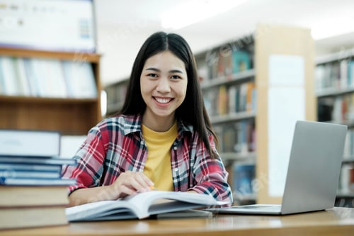 Preview: Portrait of a Smart Beautiful Asian Girl Studing and Reading Text Books Smiling Looking at Camera.